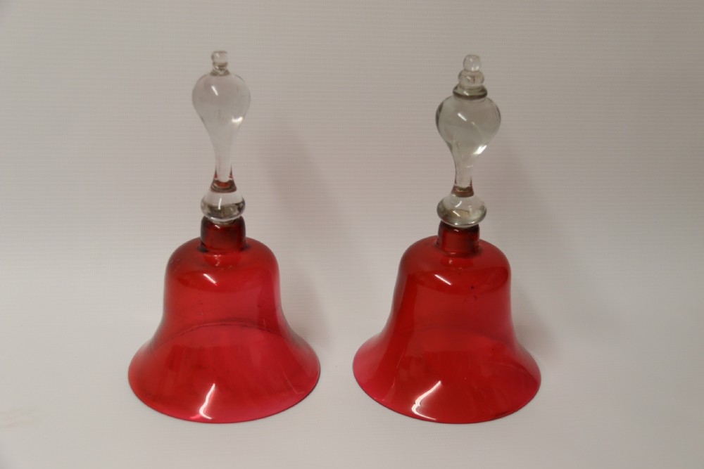 A pair of Victorian hand bells crafted from ruby red glass with clear glass baluster handles. View IV