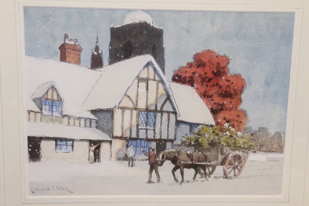 A pair of framed 1930s watercolour paintings by Ernest Uden depicting snowy rural winter scenes featuring a windmill and a timber-framed building. View III