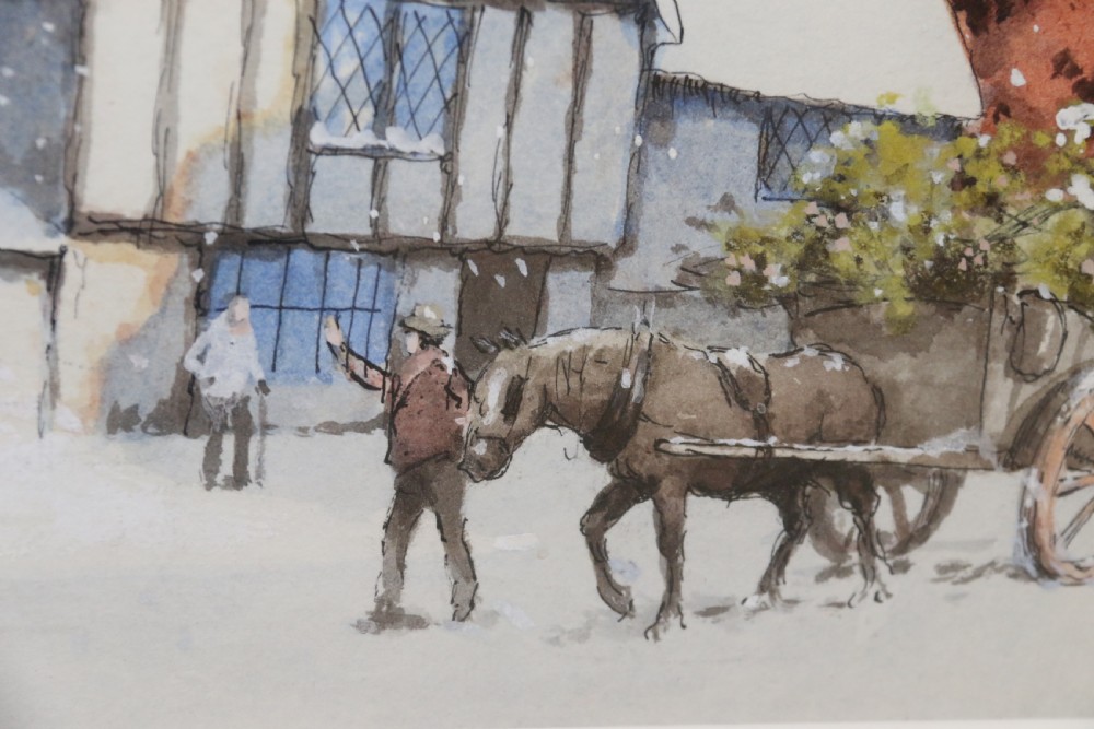 A pair of framed 1930s watercolour paintings by Ernest Uden depicting snowy rural winter scenes featuring a windmill and a timber-framed building. View VII