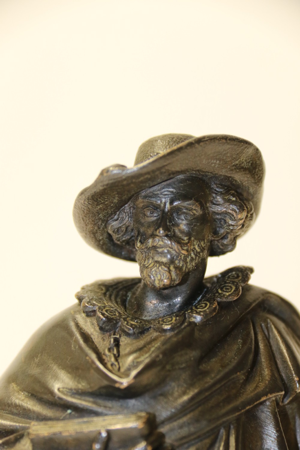 A nineteenth-century patinated bronze sculpture depicting painter Anthony van Dyck in seventeenth-century dress standing on a circular integral base. View V