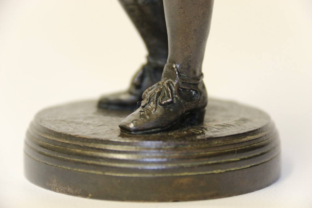 A nineteenth-century patinated bronze sculpture depicting painter Anthony van Dyck in seventeenth-century dress standing on a circular integral base. View X