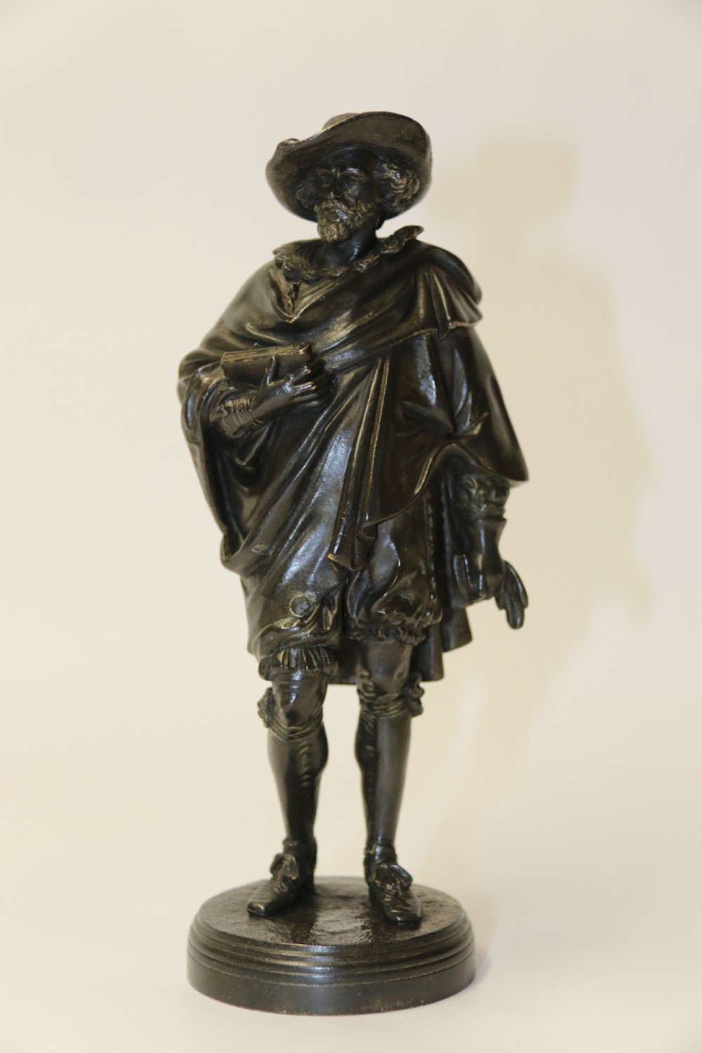 A nineteenth-century patinated bronze sculpture depicting painter Anthony van Dyck in seventeenth-century dress standing on a circular integral base. View XIII