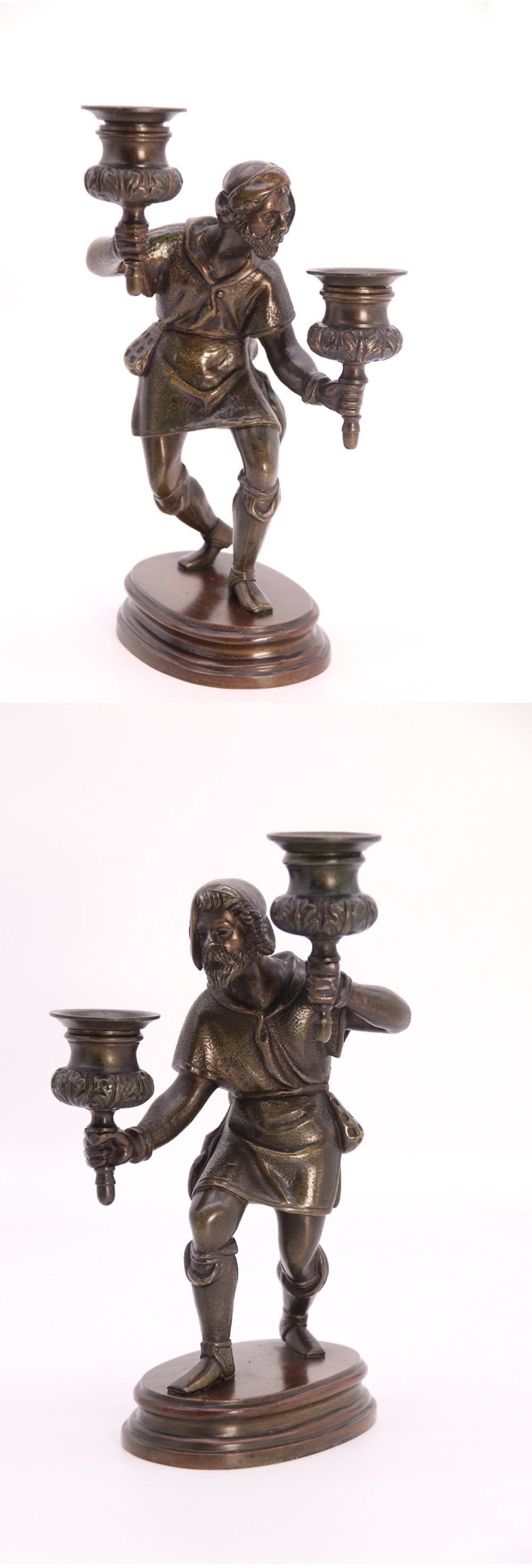 A pair of 19th-century patinated dark bronze double candlesticks featuring sculpted male figures standing on oval bases and holding two sconces each.