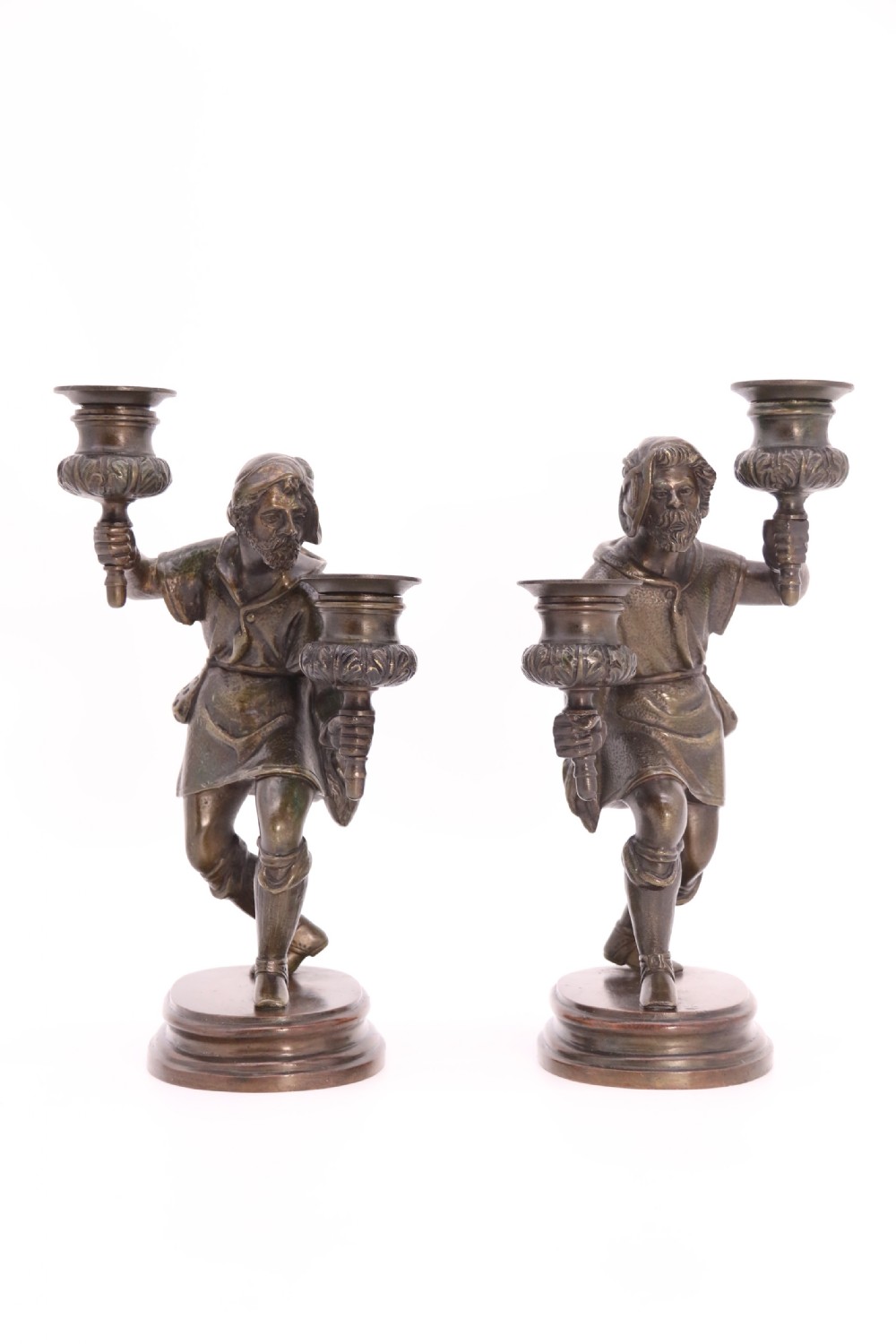 A pair of 19th-century patinated dark bronze double candlesticks featuring sculpted male figures standing on oval bases and holding two sconces each. View V