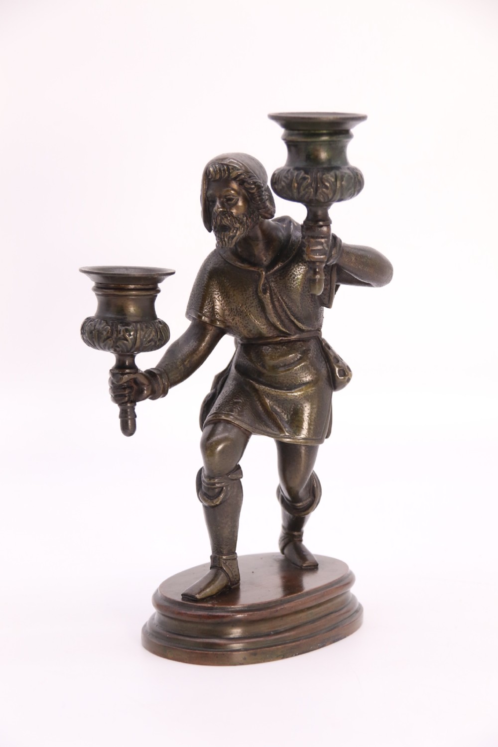 A pair of 19th-century patinated dark bronze double candlesticks featuring sculpted male figures standing on oval bases and holding two sconces each. View XVIII