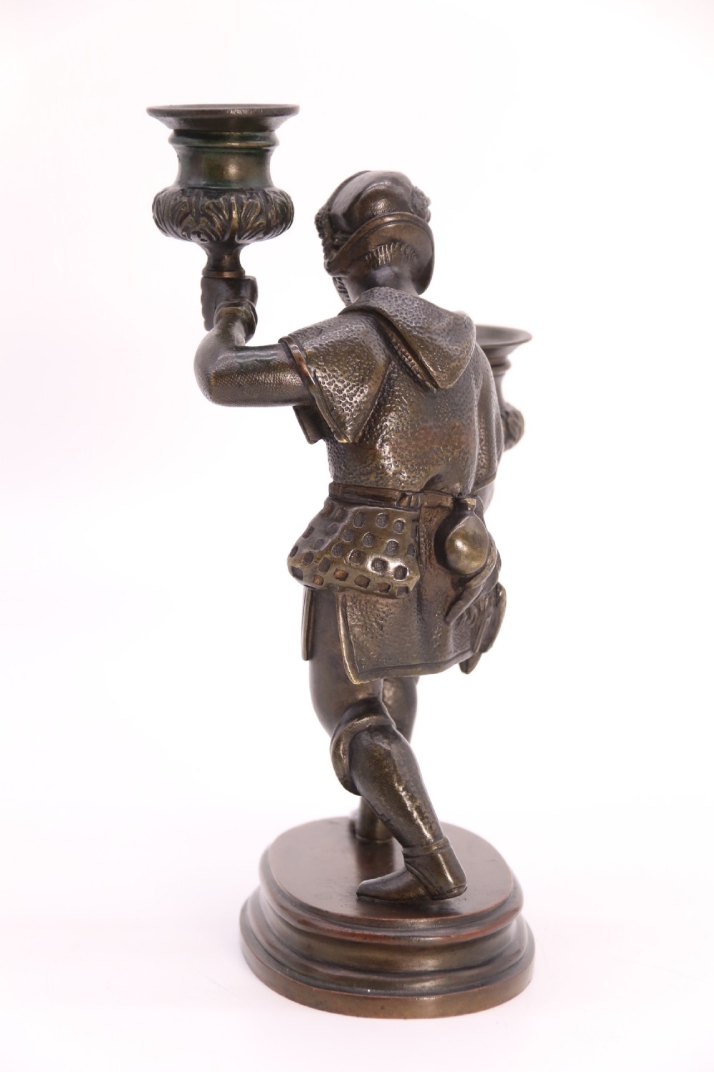 A pair of 19th-century patinated dark bronze double candlesticks featuring sculpted male figures standing on oval bases and holding two sconces each. View XX