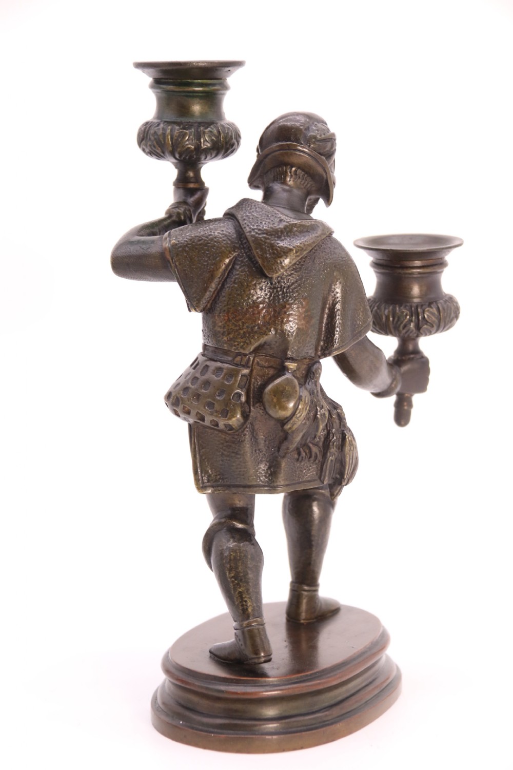 A pair of 19th-century patinated dark bronze double candlesticks featuring sculpted male figures standing on oval bases and holding two sconces each. View XXI