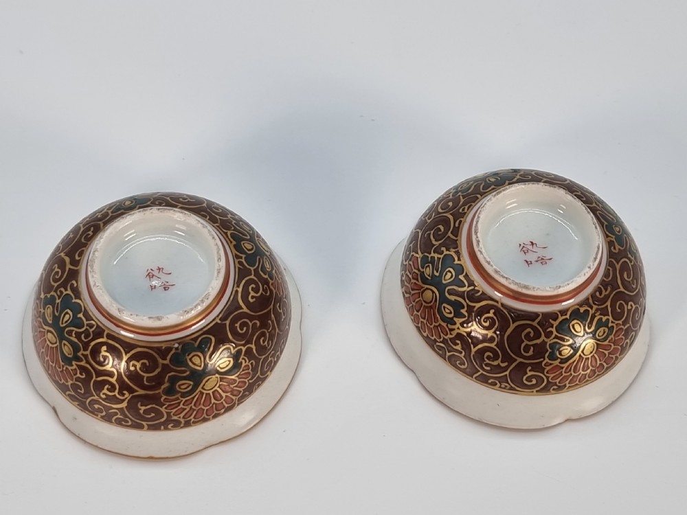 A pair of round Japanese Kutani porcelain miniature bowls with lobed gilded rims and interior hand-painted enamel chrysanthemum motifs. View V