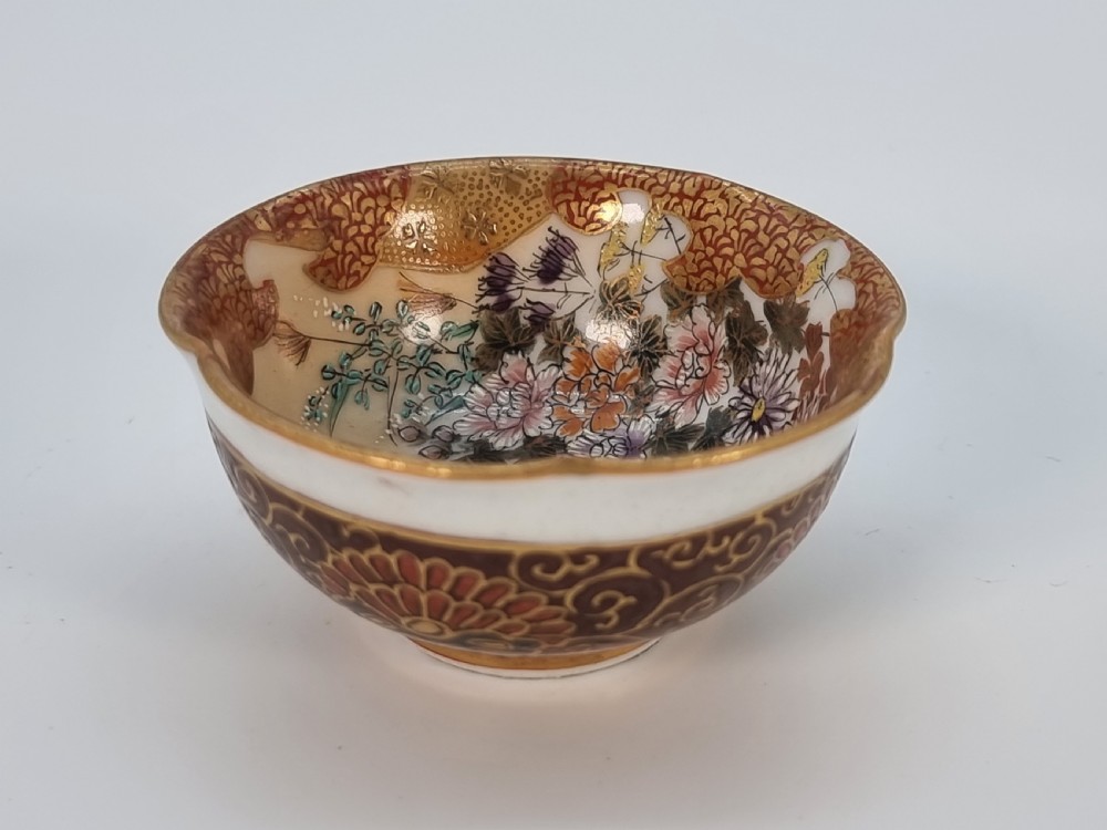 A pair of round Japanese Kutani porcelain miniature bowls with lobed gilded rims and interior hand-painted enamel chrysanthemum motifs. View VII