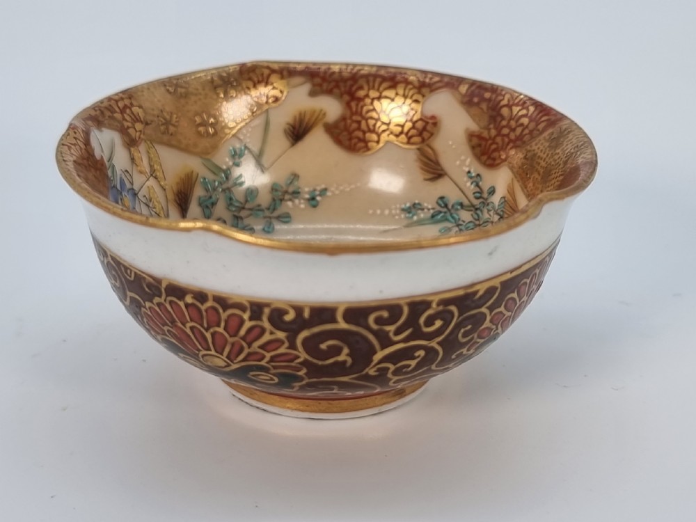 A pair of round Japanese Kutani porcelain miniature bowls with lobed gilded rims and interior hand-painted enamel chrysanthemum motifs. View X