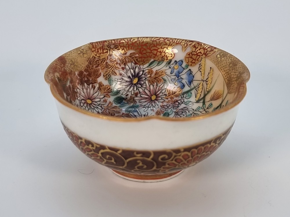 A pair of round Japanese Kutani porcelain miniature bowls with lobed gilded rims and interior hand-painted enamel chrysanthemum motifs. View XV