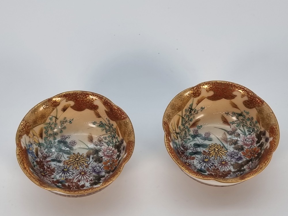 A pair of round Japanese Kutani porcelain miniature bowls with lobed gilded rims and interior hand-painted enamel chrysanthemum motifs. View XIX