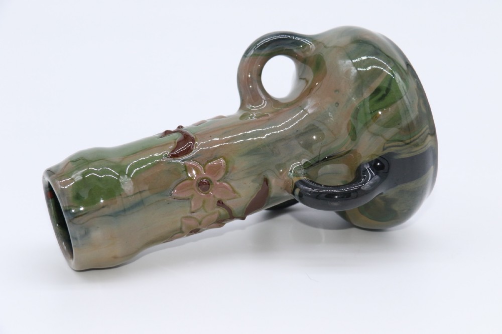 A green and brown glazed earthenware ceramic vase featuring three handles and raised slipware floral decoration. View VIII