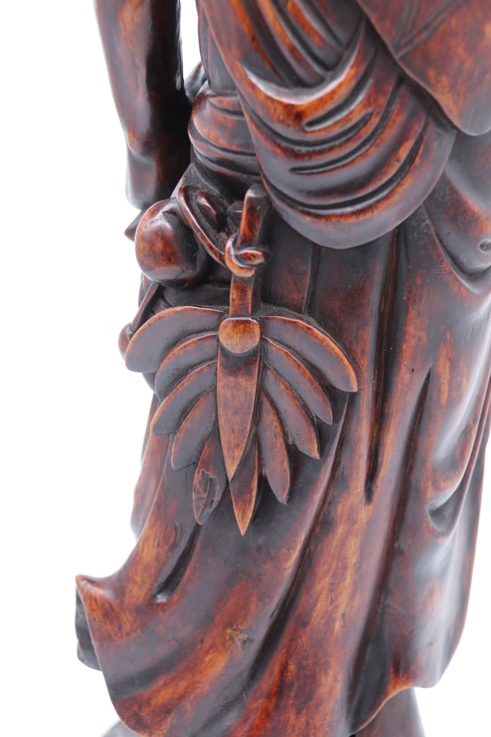 A late 19th-century Japanese Meiji period carved hardwood okimono depicting a standing male figure with a staff, scroll, and fruit on a textured base. View XXIX