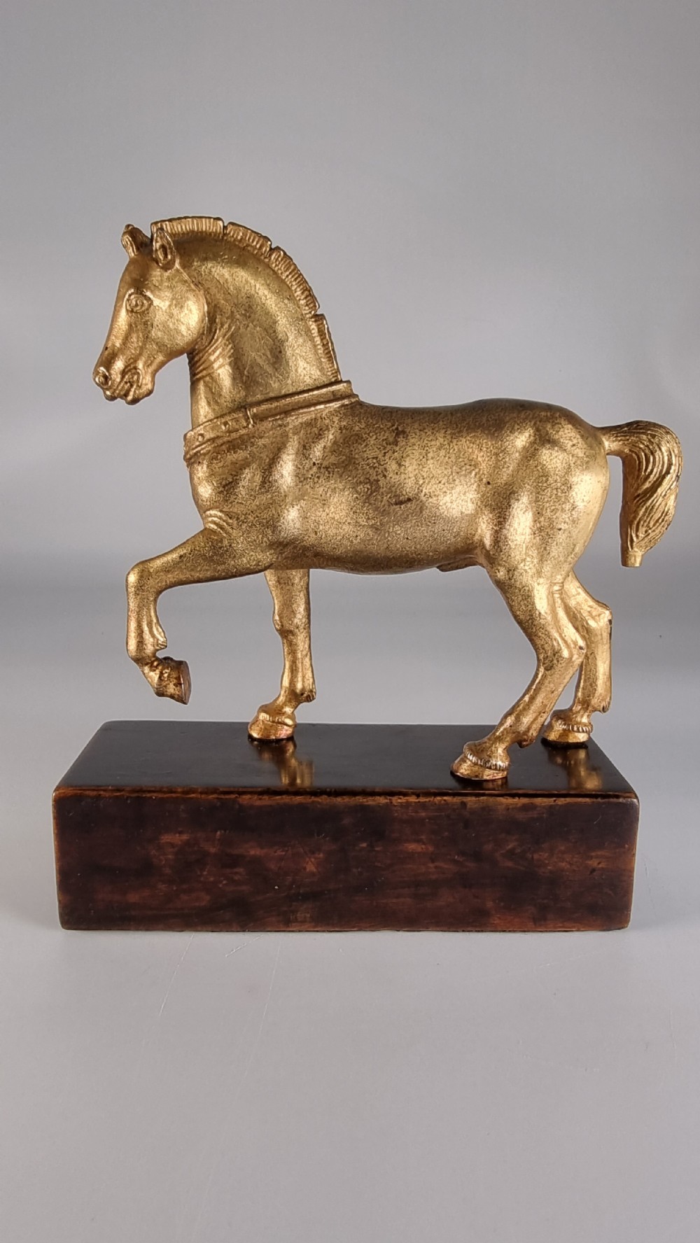 A pair of 19th-century Italian gilt bronze horse sculptures depicted facing each other, mounted on rectangular dark olive wood bases. View VII