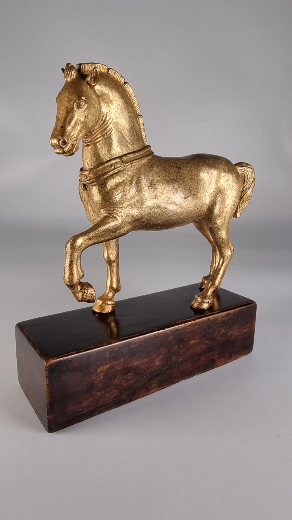 A pair of 19th-century Italian gilt bronze horse sculptures depicted facing each other, mounted on rectangular dark olive wood bases. View VIII