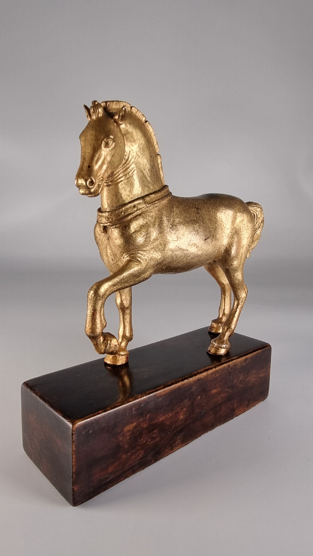 A pair of 19th-century Italian gilt bronze horse sculptures depicted facing each other, mounted on rectangular dark olive wood bases. View XI