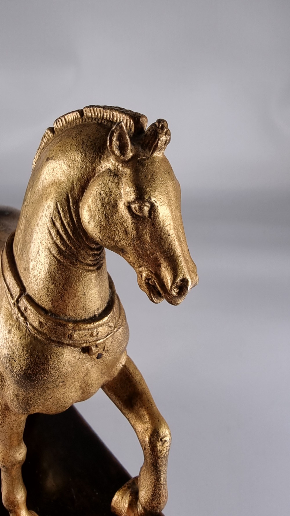 A pair of 19th-century Italian gilt bronze horse sculptures depicted facing each other, mounted on rectangular dark olive wood bases. View XIII