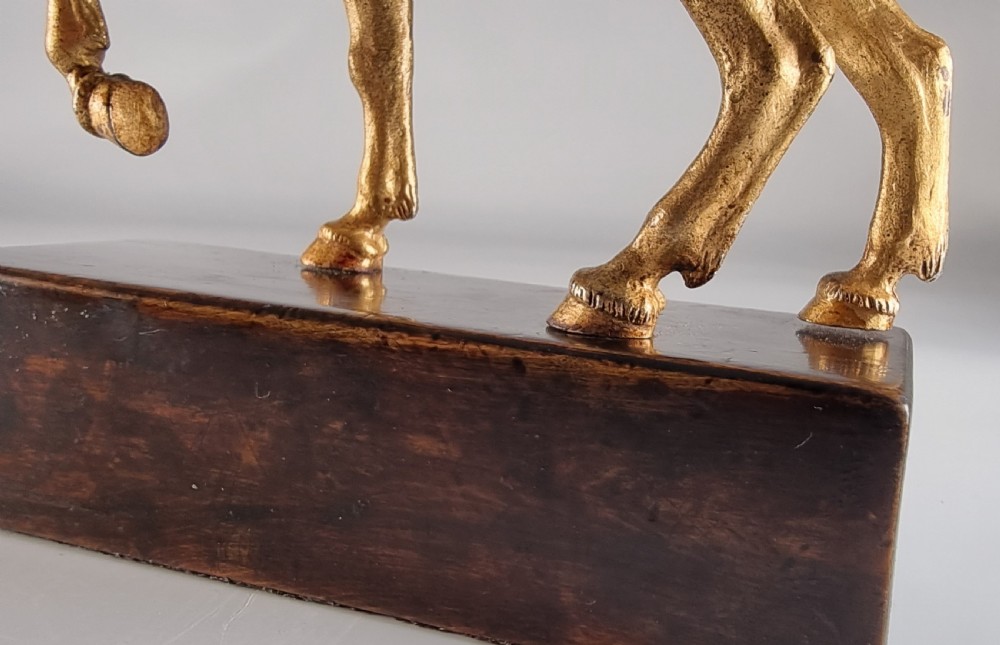 A pair of 19th-century Italian gilt bronze horse sculptures depicted facing each other, mounted on rectangular dark olive wood bases. View XV