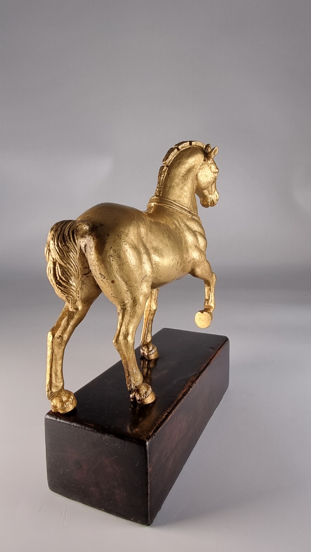 A pair of 19th-century Italian gilt bronze horse sculptures depicted facing each other, mounted on rectangular dark olive wood bases. View XIX