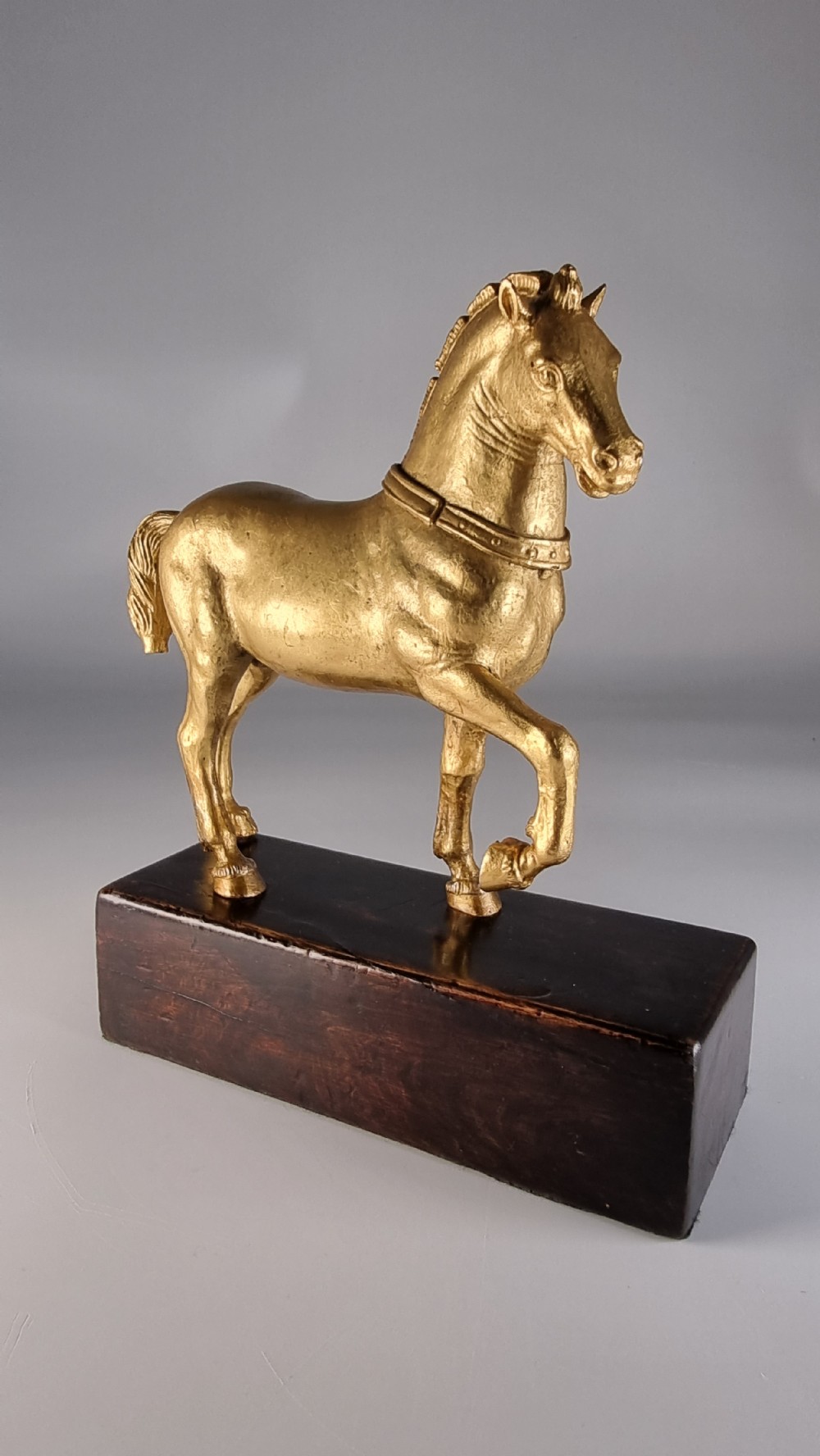 A pair of 19th-century Italian gilt bronze horse sculptures depicted facing each other, mounted on rectangular dark olive wood bases. View XXI