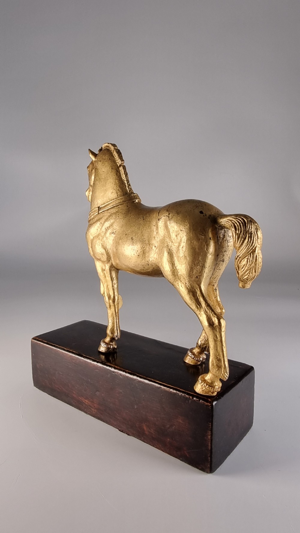 A pair of 19th-century Italian gilt bronze horse sculptures depicted facing each other, mounted on rectangular dark olive wood bases. View XXV