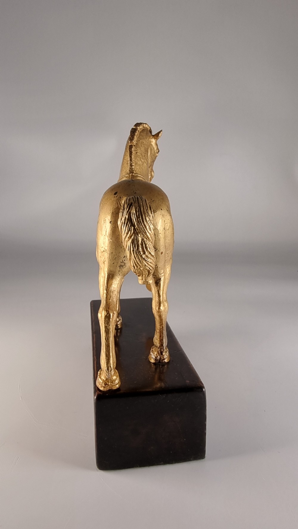 A pair of 19th-century Italian gilt bronze horse sculptures depicted facing each other, mounted on rectangular dark olive wood bases. View XXVI
