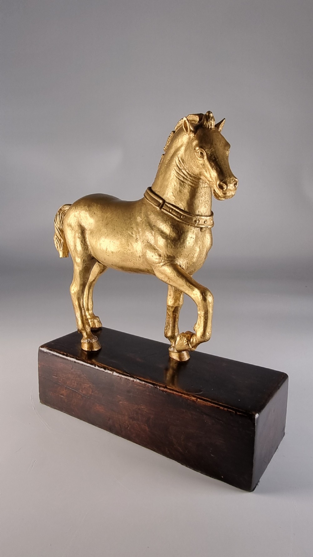 A pair of 19th-century Italian gilt bronze horse sculptures depicted facing each other, mounted on rectangular dark olive wood bases. View XXIX