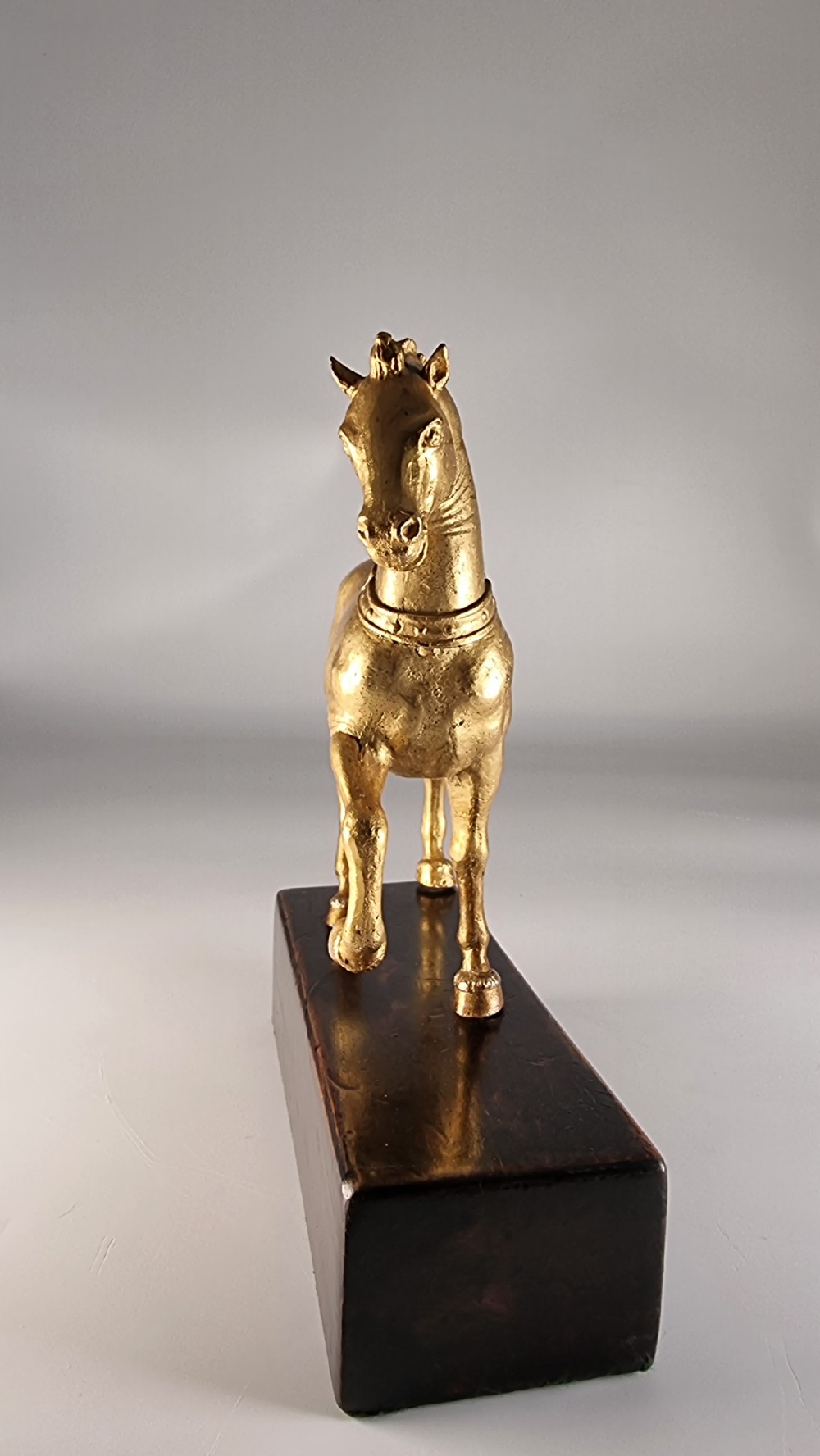 A pair of 19th-century Italian gilt bronze horse sculptures depicted facing each other, mounted on rectangular dark olive wood bases. View XXX