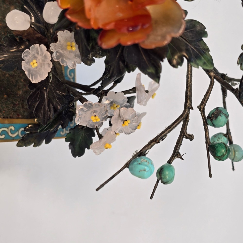 A carved hardstone flowering bonsai tree with colourful semi-precious stone petals set inside a rectangular blue cloisonne enamel pot. View XIV
