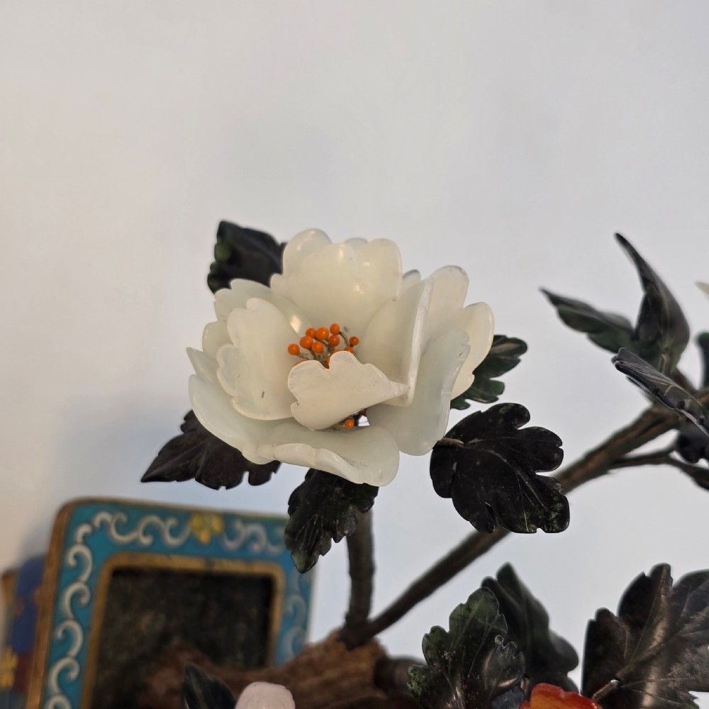 A carved hardstone flowering bonsai tree with colourful semi-precious stone petals set inside a rectangular blue cloisonne enamel pot. View XV