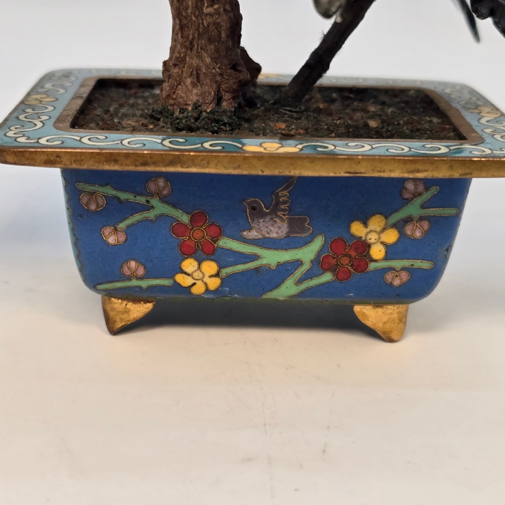 A carved hardstone flowering bonsai tree with colourful semi-precious stone petals set inside a rectangular blue cloisonne enamel pot. View XVII