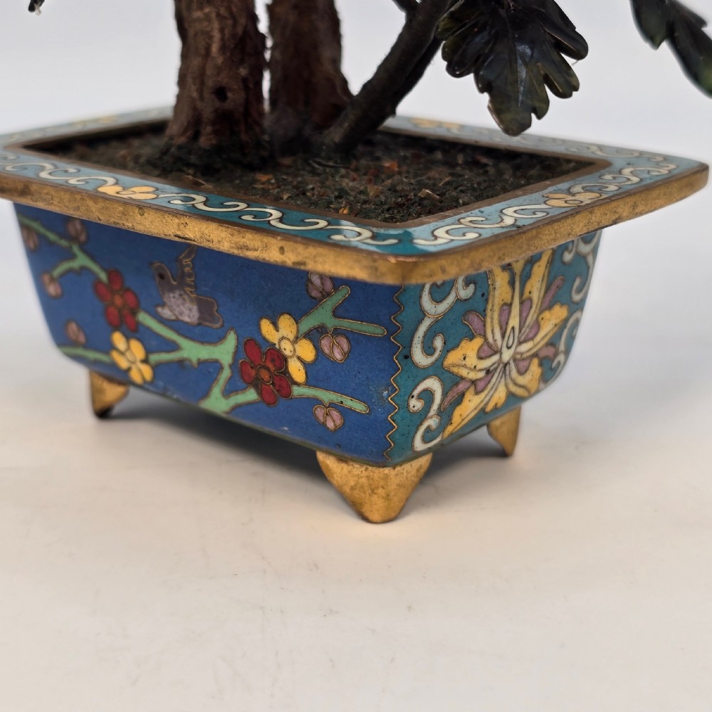 A carved hardstone flowering bonsai tree with colourful semi-precious stone petals set inside a rectangular blue cloisonne enamel pot. View XVIII