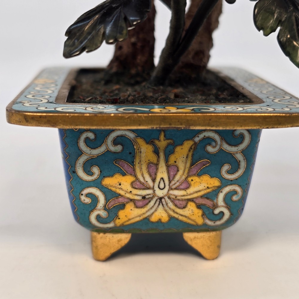 A carved hardstone flowering bonsai tree with colourful semi-precious stone petals set inside a rectangular blue cloisonne enamel pot. View XIX