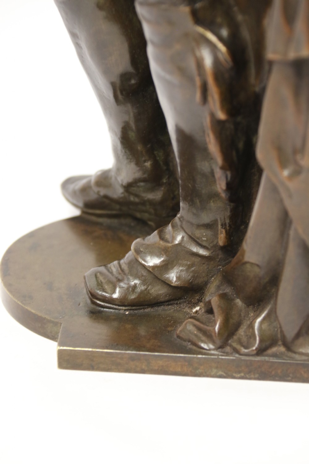 A patinated dark brown bronze sculpture depicting a standing male musician playing a mandolin while wearing a draped coat and headwear. View XIV