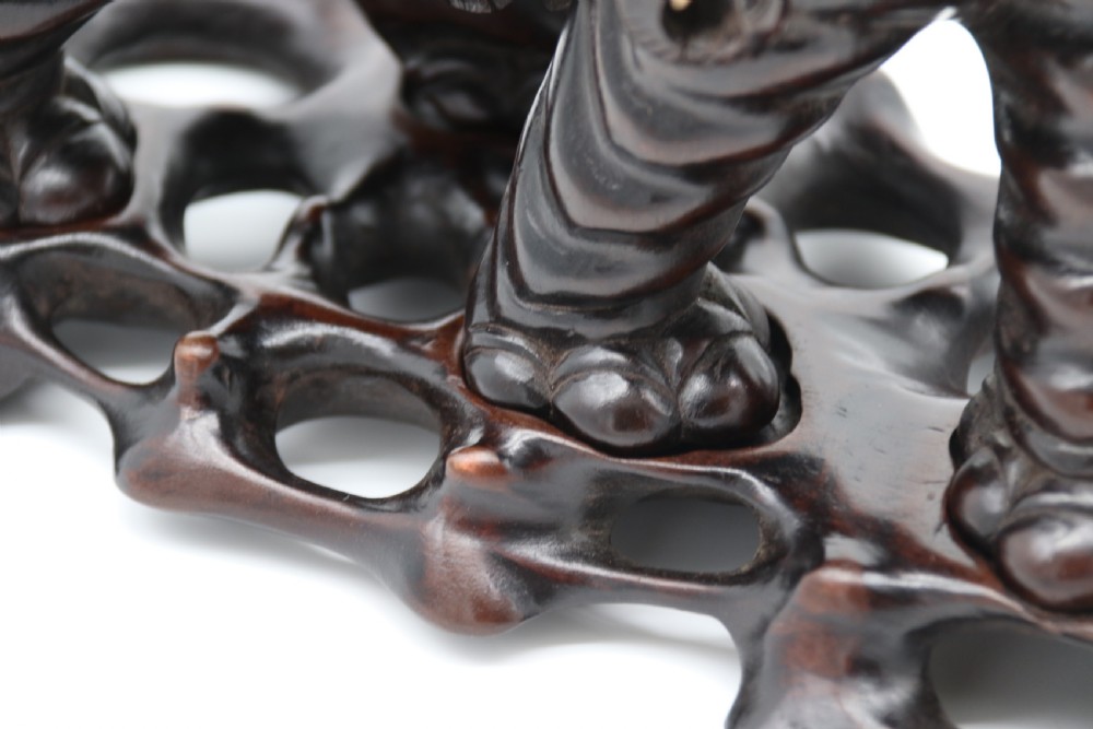 A pair of hand-carved dark hardwood elephant figures standing on pierced wooden bases with exposed tusks. View XV