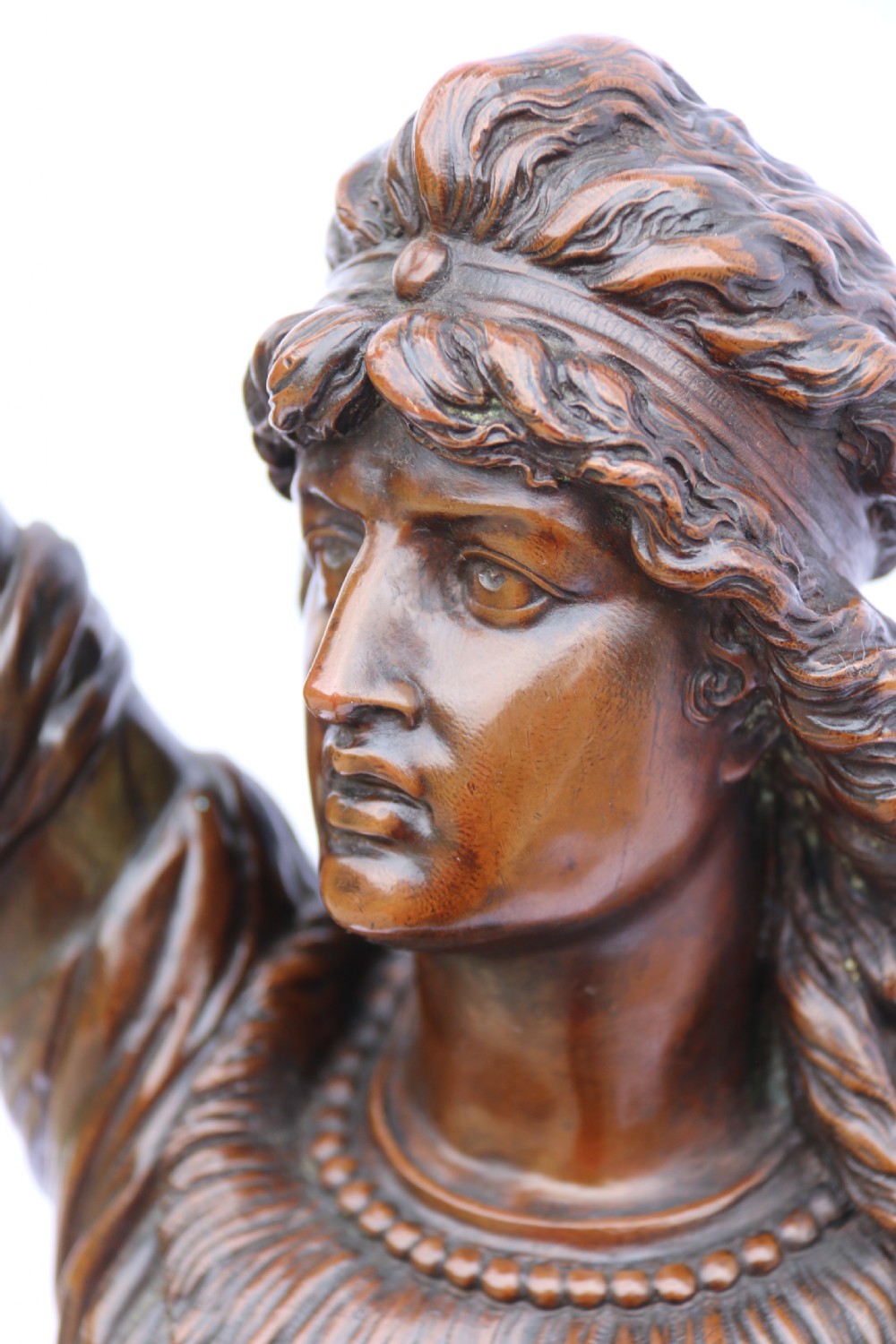 A 19th-century dark patinated bronze sculpture depicting Queen Boadicea in draped robes raising a dagger in her right hand while standing on a rocky base. View XII