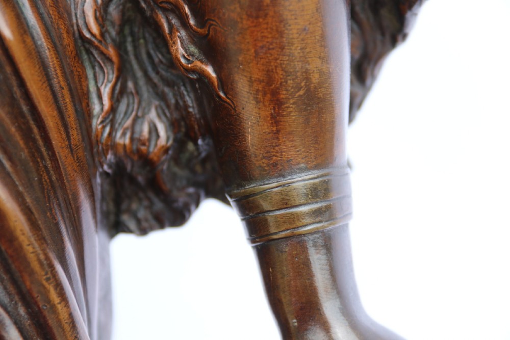 A 19th-century dark patinated bronze sculpture depicting Queen Boadicea in draped robes raising a dagger in her right hand while standing on a rocky base. View XVII