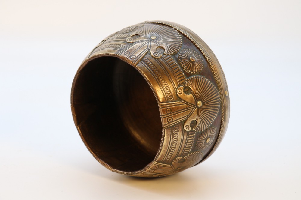A pair of mid-19th-century Indian brass ceremonial bowls featuring intricate hand-engraved bird and sunburst motifs. View V