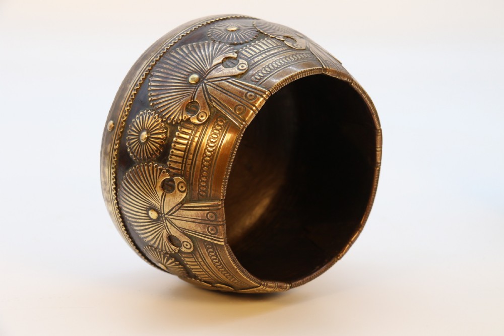 A pair of mid-19th-century Indian brass ceremonial bowls featuring intricate hand-engraved bird and sunburst motifs. View X