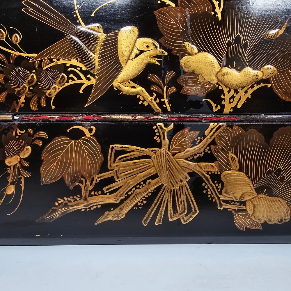 A black lacquer Japanese writing box decorated with detailed gold botanical and bird illustrations, featuring a hinged lid opening to internal correspondence slots. View II