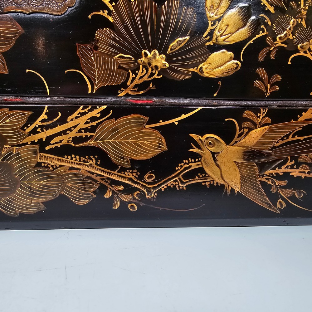 A black lacquer Japanese writing box decorated with detailed gold botanical and bird illustrations, featuring a hinged lid opening to internal correspondence slots. View III