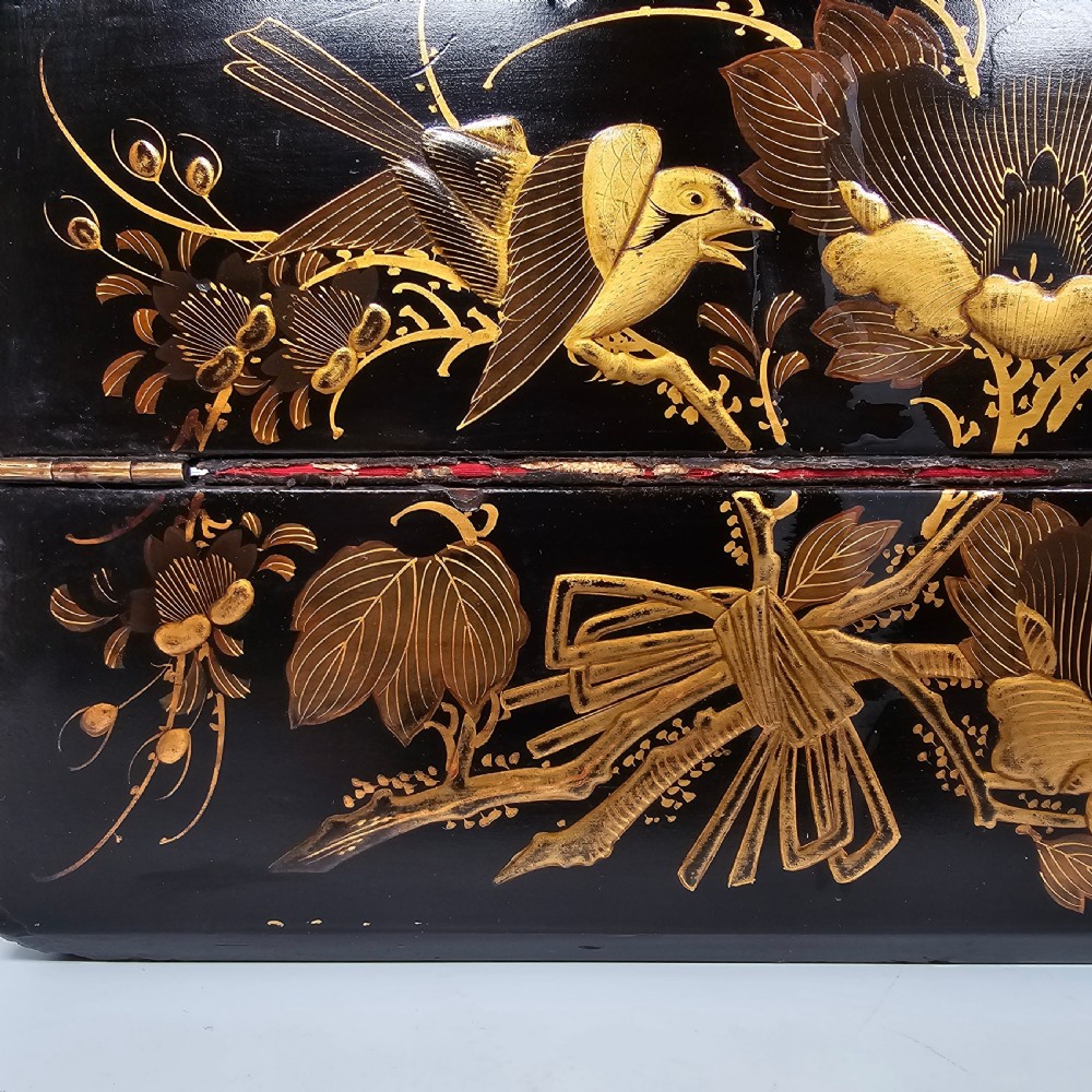 A black lacquer Japanese writing box decorated with detailed gold botanical and bird illustrations, featuring a hinged lid opening to internal correspondence slots. View IV