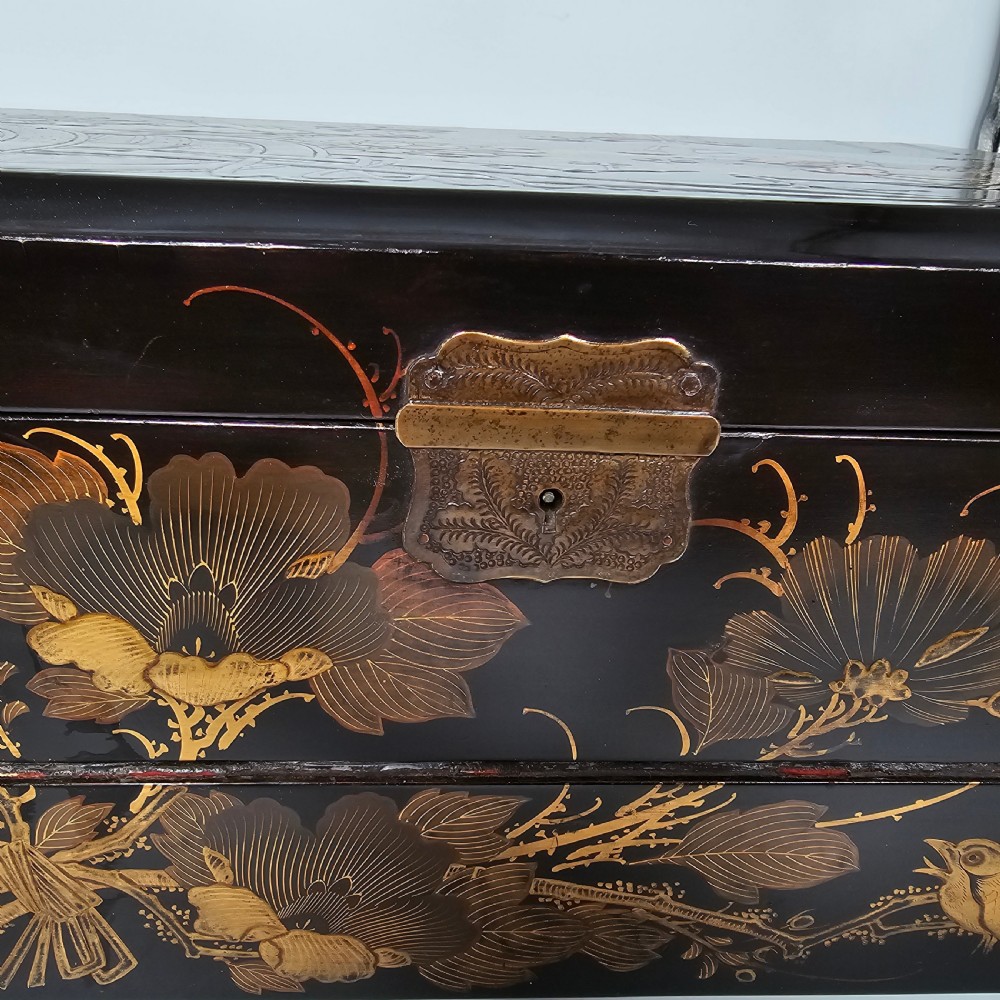 A black lacquer Japanese writing box decorated with detailed gold botanical and bird illustrations, featuring a hinged lid opening to internal correspondence slots. View V