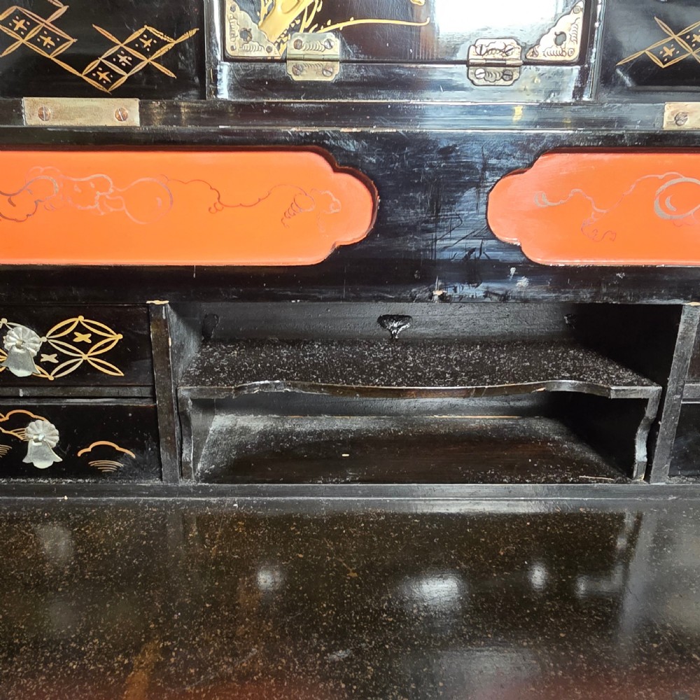 A black lacquer Japanese writing box decorated with detailed gold botanical and bird illustrations, featuring a hinged lid opening to internal correspondence slots. View X