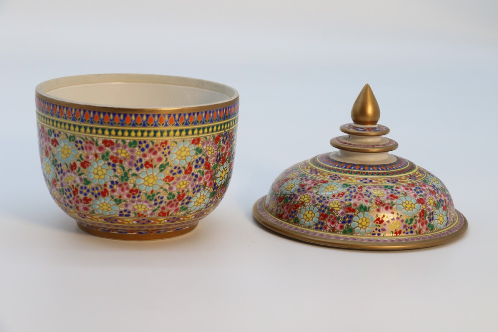 A polychrome enamelled ceramic jar with a fitted stepped lid featuring intricate floral motifs and a gilded conical finial. View IV