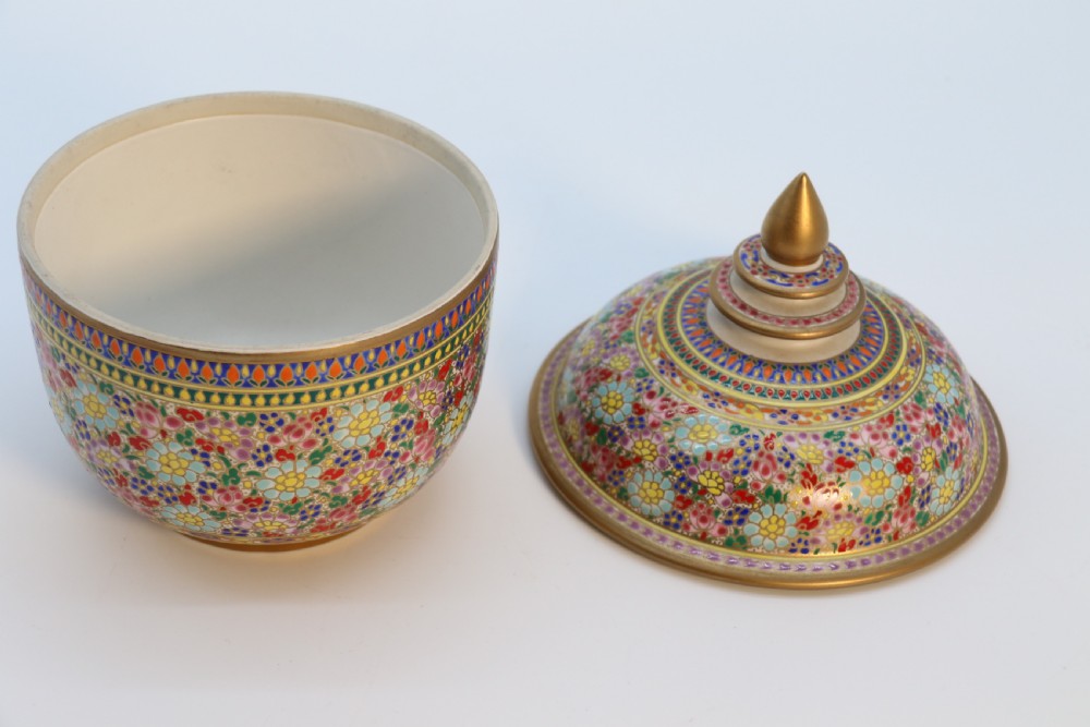 A polychrome enamelled ceramic jar with a fitted stepped lid featuring intricate floral motifs and a gilded conical finial. View V