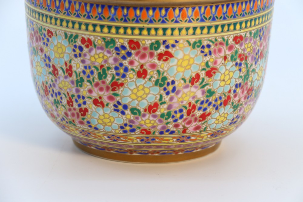 A polychrome enamelled ceramic jar with a fitted stepped lid featuring intricate floral motifs and a gilded conical finial. View XIII