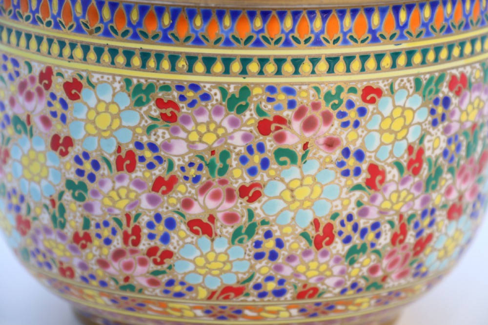 A polychrome enamelled ceramic jar with a fitted stepped lid featuring intricate floral motifs and a gilded conical finial. View XVI