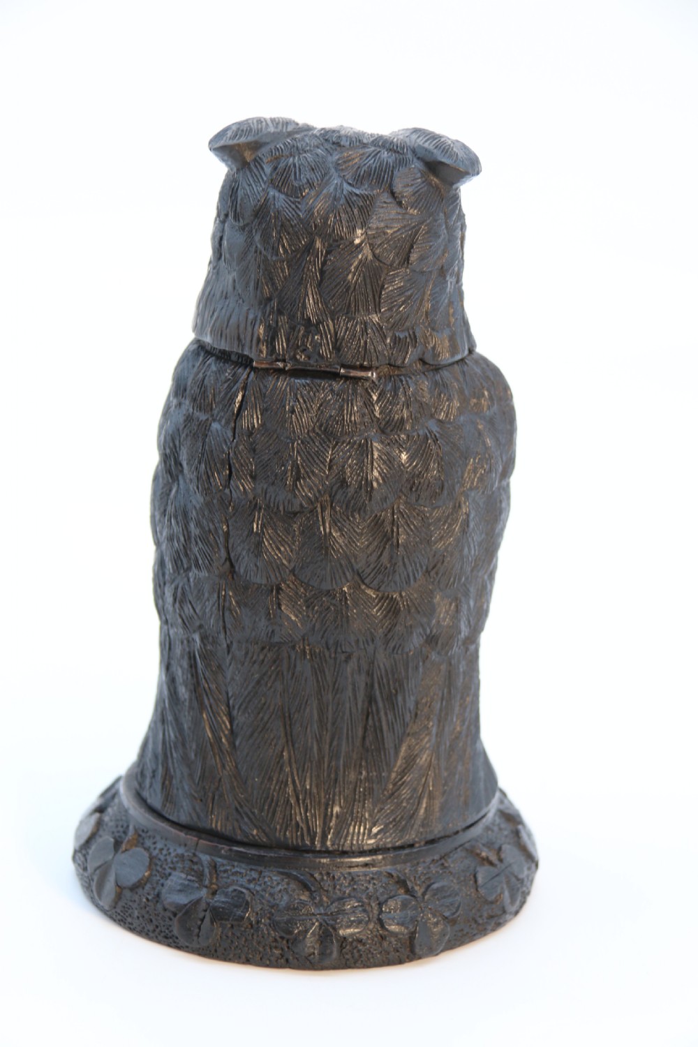 A hand-carved dark oak inkstand crafted in the likeness of an owl with glass eyes and a brass tether, resting on a carved base with shamrock details. View VI